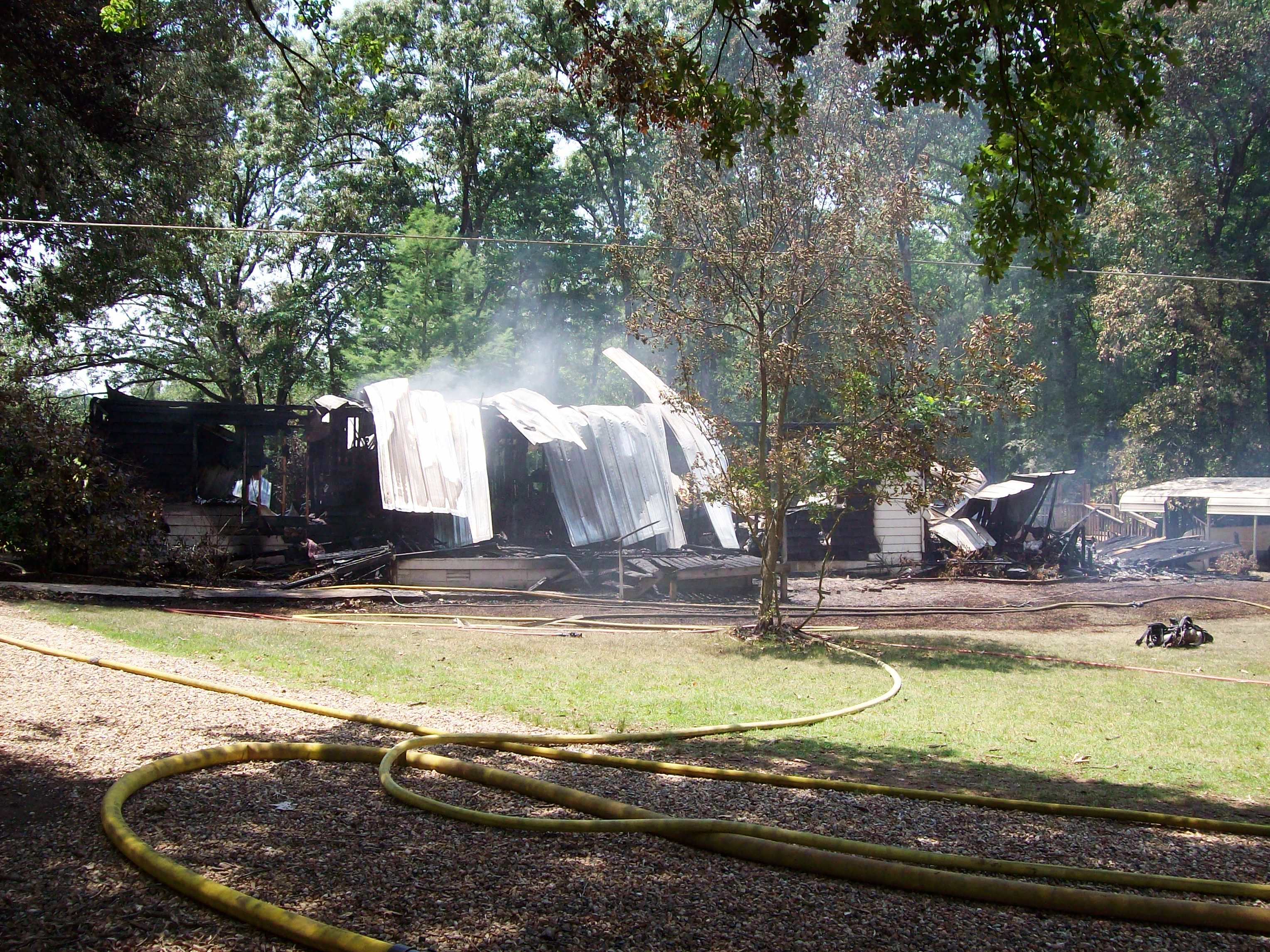 Smoke still rising from the burned house.